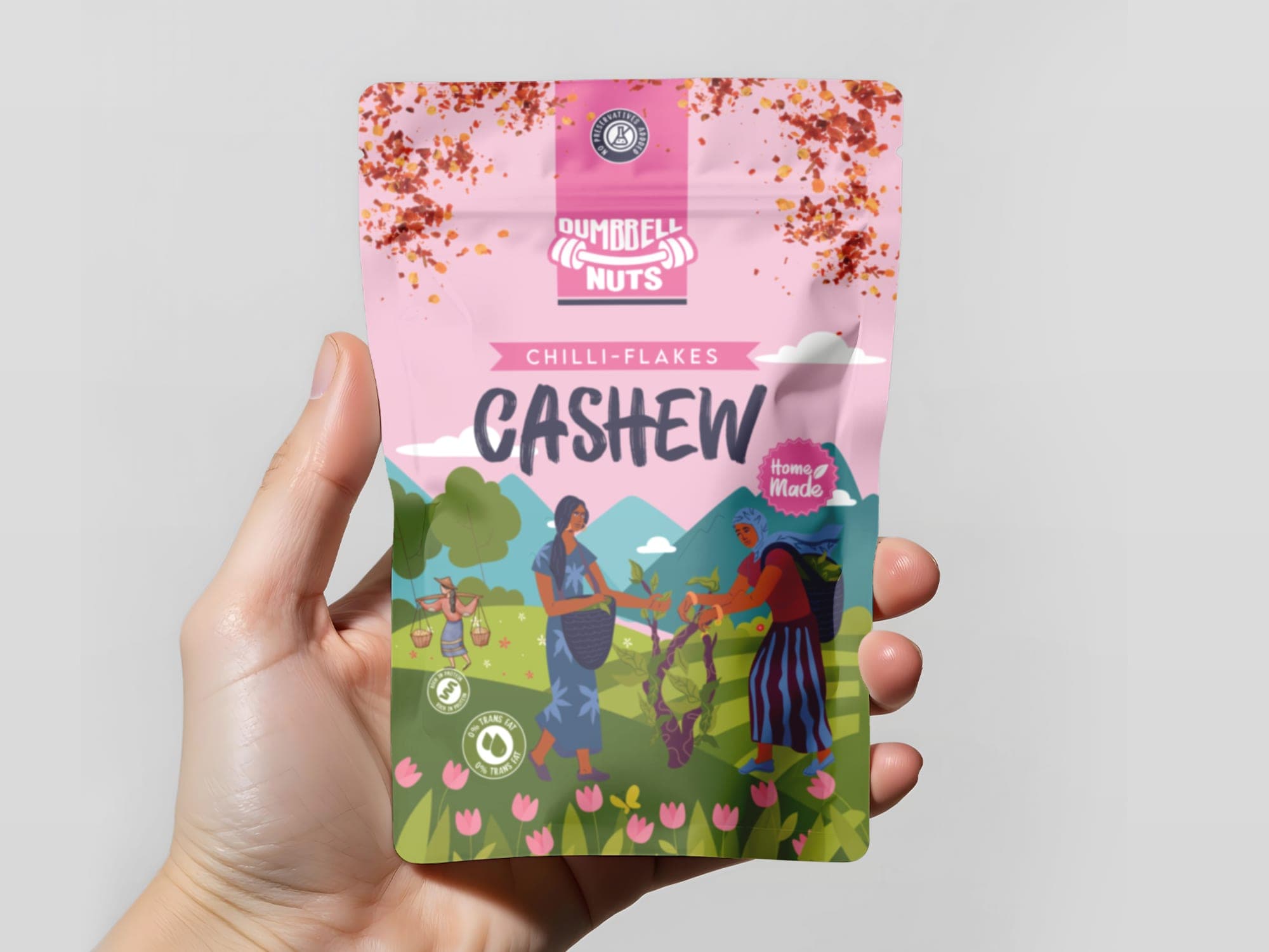 A hand holding the chilli-flakes cashew pouch to show in-hand pack scale