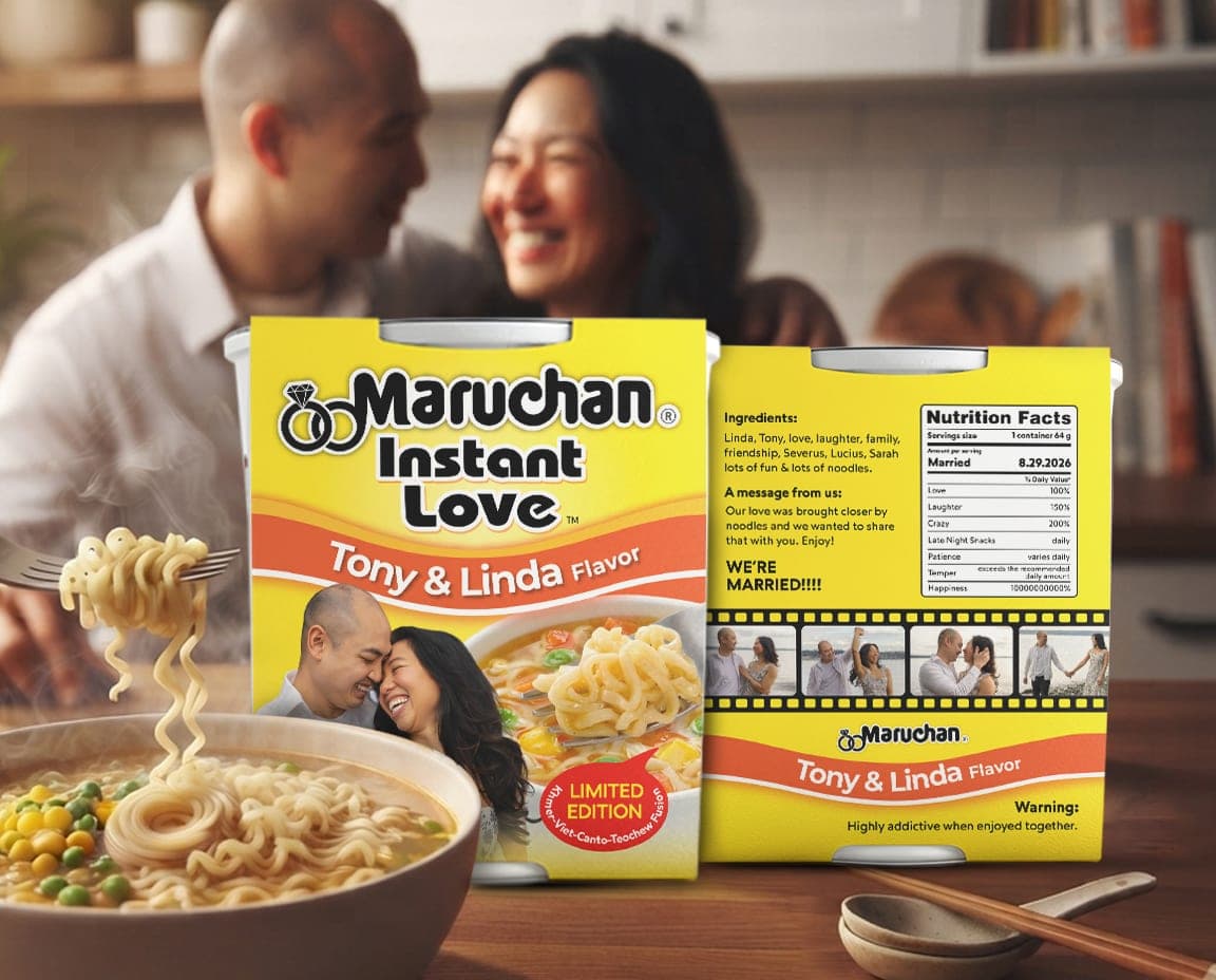 The Instant Love cup styled on a kitchen table beside a steaming bowl of noodles